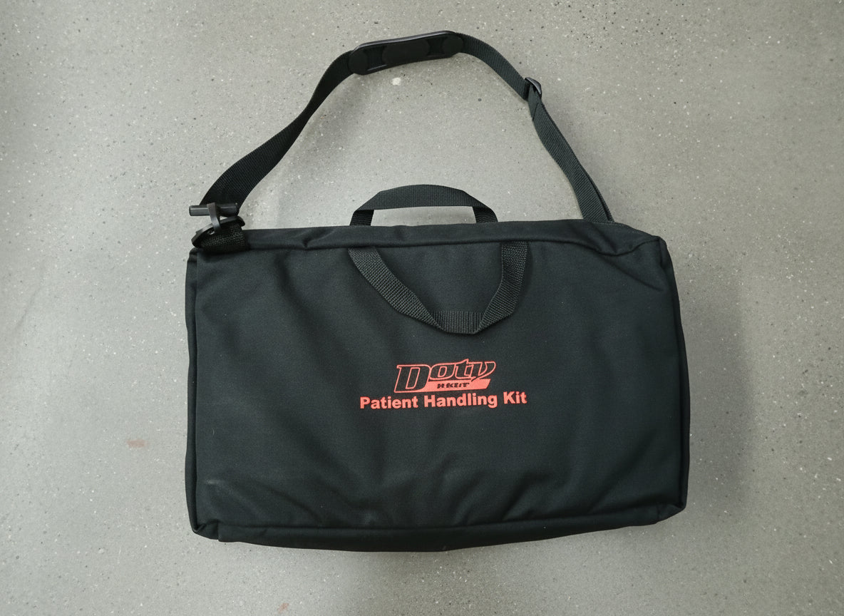 Black patient handling kit bag with red text on a brown surface